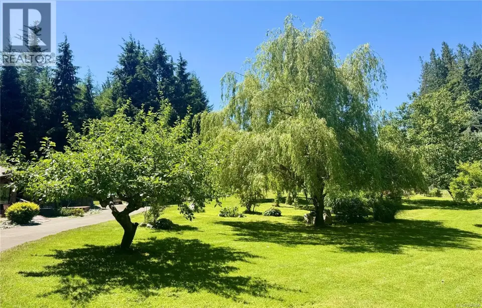 The privately fenced property is landscaped with exceptionally beautiful trees and perrenials.