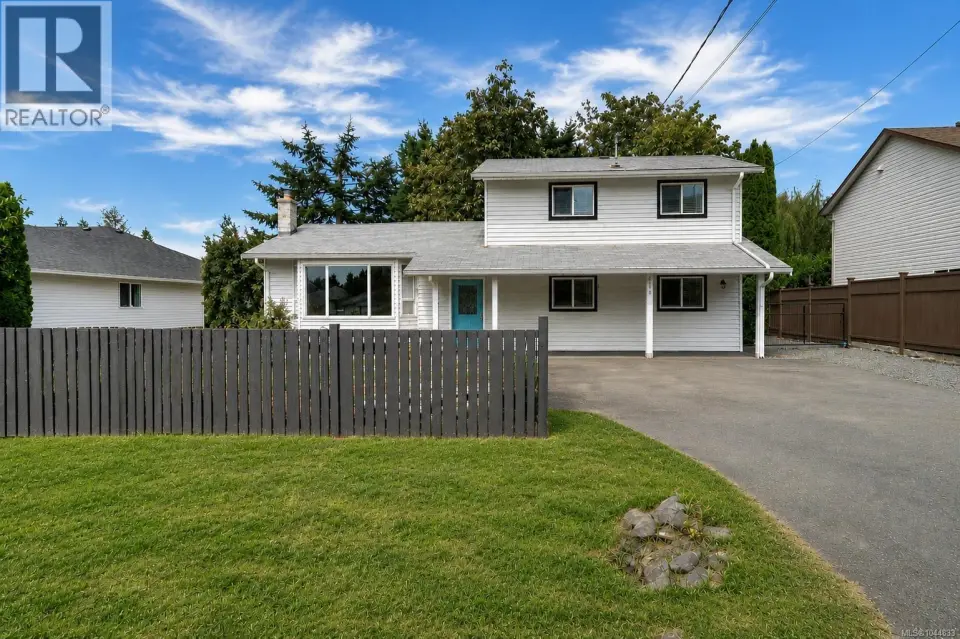 Two-story residence with white siding and contrasting black window trim