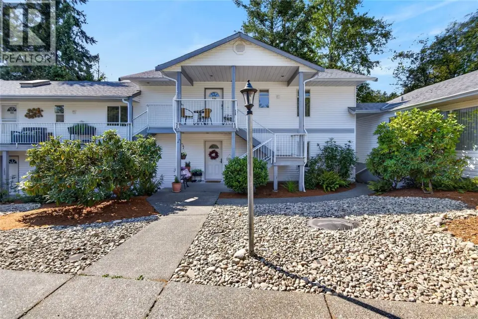 Multi-level exterior with white siding and gray trim