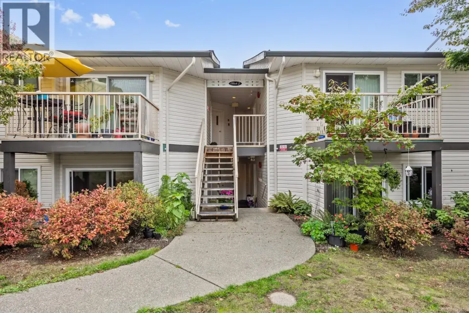 Multi-level building with horizontal siding and multiple balconies