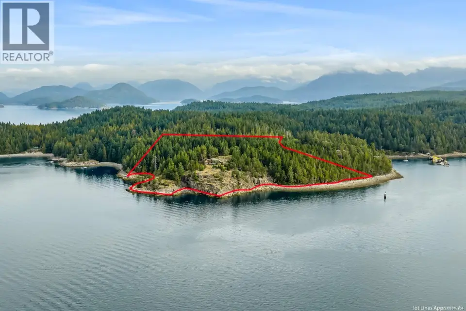 Waterfront parcel with mature evergreen trees and rugged rock outcroppings